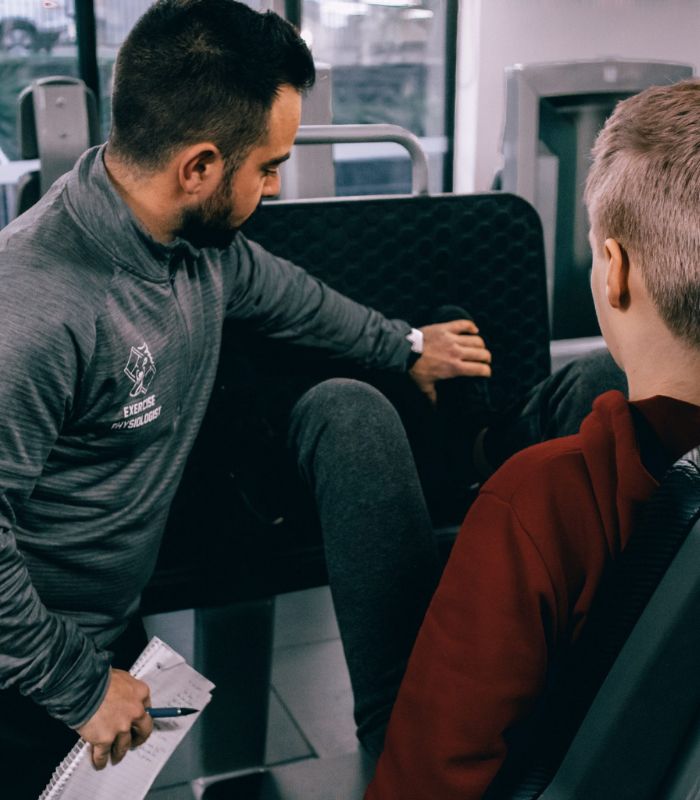 Strength and Conditioning trainer assisting client’s movement.